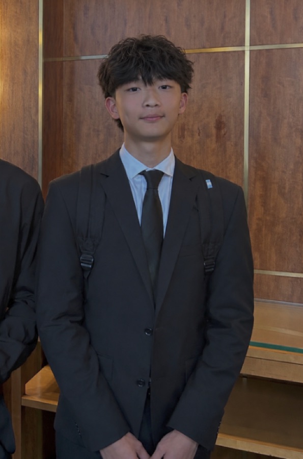 Brandon Lee, founder of UVision Initiative, in a dark suit and tie.