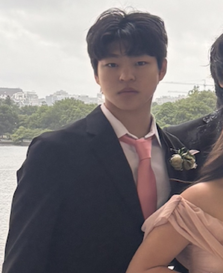 Forest Lan, vice president of UVision Initiative, in a dark suit by a lake.